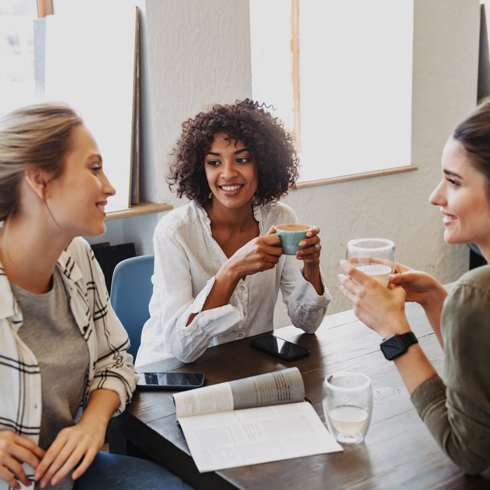 A group of women sitting and having coffee